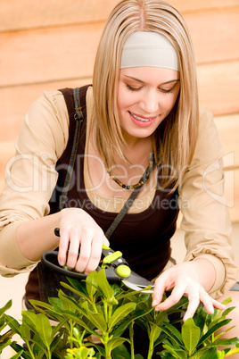 Gardening woman pruning plants in spring
