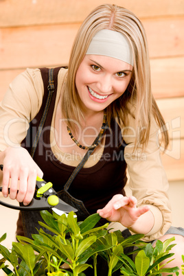 Gardening woman pruning plants in spring