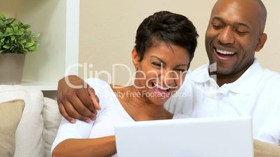 African American Couple Using Laptop at Home
