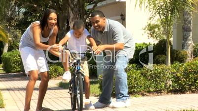 Young African American Boy Riding on his Bicycle