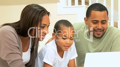 Parents & Son Using Laptop Computer