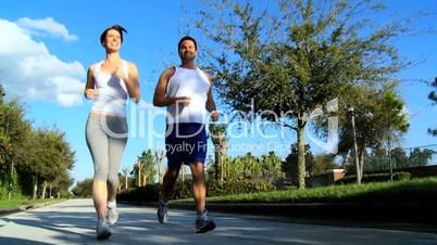 Young Couple Jogging on Suburban Roads