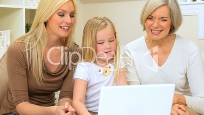 Three Female Generations Using Laptop Computer