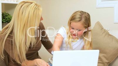 Mom & Young Daughter Using Laptop Computer