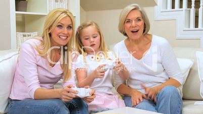 Cute Little Girl Playing Games Console with Family