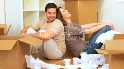 Couple Sitting on Floor of New Home