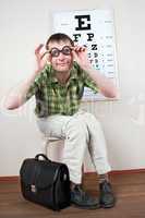 person wearing spectacles in an office at the doctor