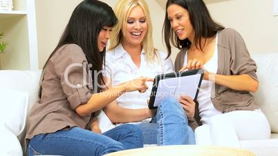 Three Pretty Girlfriends With a Wireless Tablet