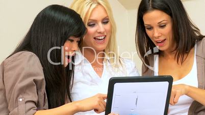 Multi-Ethnic Girlfriends Using a Wireless Tablet