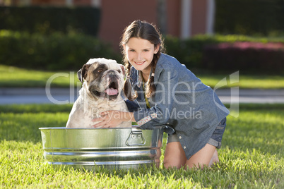 Pretty Young Girl Washing Her Pet Dog In A Tub