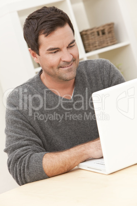 Man Using Laptop Computer At Home