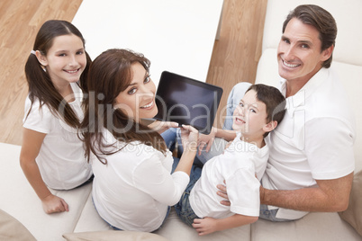 Happy Family Having Fun Using Tablet Computer At Home