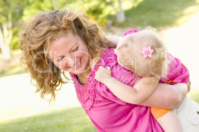 Mother and Daughter Piggyback in the Park