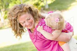 Mother and Daughter Piggyback in the Park