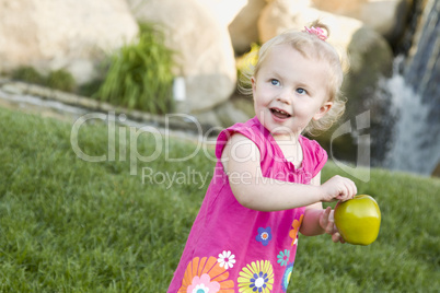 Smiling Young Girl in The Park Holding Apple