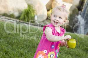 Smiling Young Girl in The Park Holding Apple