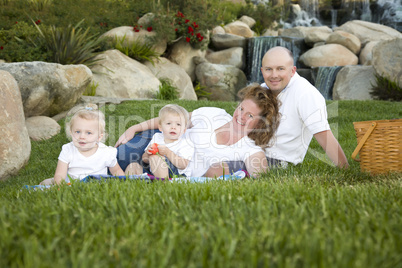 Happy Young Family with Twins Portrait in Park