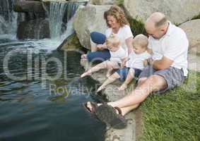 Young Family with Twins Enjoy Water in Park
