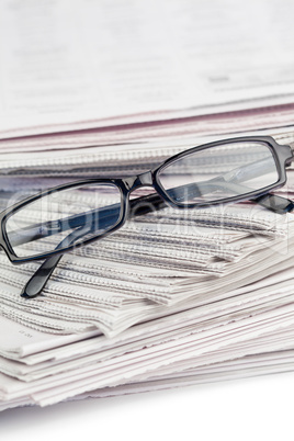 Newspapers and black glasses