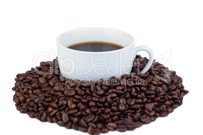 Small cup of coffee and coffee beans