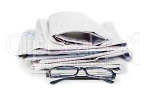 Newspapers and black glasses