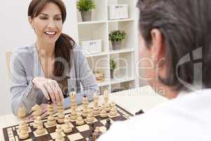 Happy Man & Woman Couple Playing Chess