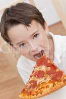 Young Boy Child Eating Slice of Pizza
