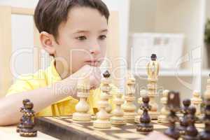 Thoughtful Young Boy Playing Chess