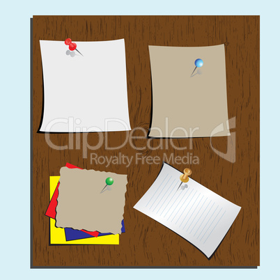 Push pins and paper notes at wood background