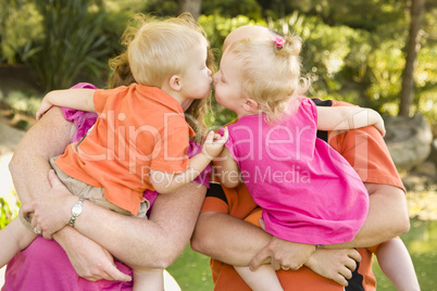 Mom and Dad Holding Kissing Brother and Sister Toddlers
