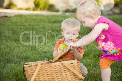 Brother and Sister Toddlers Playing with Apple and Picnic Basket