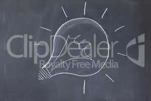 Lightbulb drawn on a blackboard symbolizing ideas