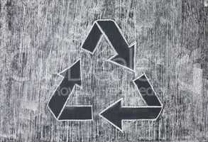 Recycle symbol on a white chalky background