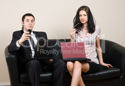 Businessmen with computers on sofa