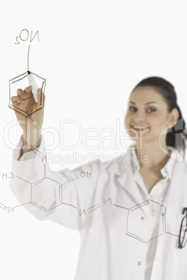 Isolated scientist writing a formula on a white board
