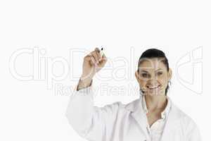 Dark-haired scientist writing on a white board