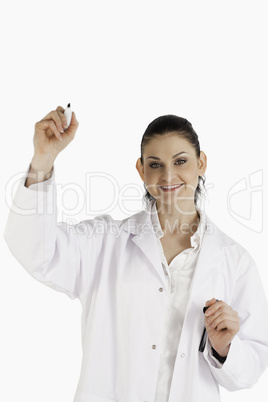 Smiling scientist writing on an empty white board
