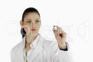 Dark-haired scientist writing on an empty white board