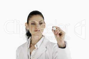 Dark-haired scientist writing on an empty white board