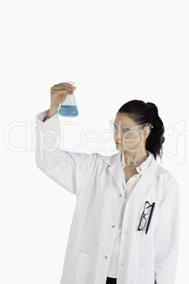 Dark-haired woman carrying out an experiment
