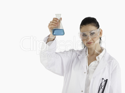 Dark-haired scientist holding a blue flask