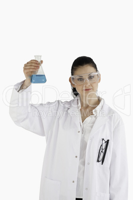 Dark-haired woman holding a blue flask