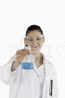 Scientist woman holding a blue flask