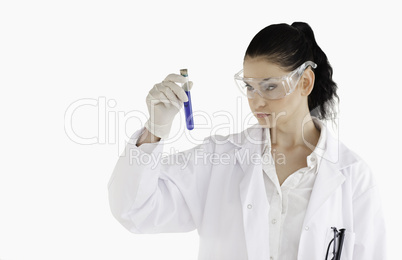 Dark-haired woman carrying out an experiment