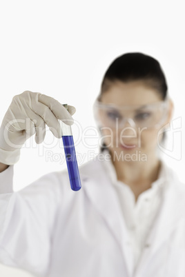 Isolated dark-haired scientist conducting an experiment