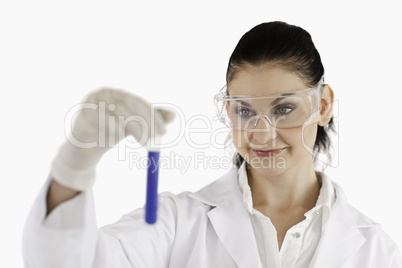 Isolated dark-haired scientist carrying out an experiment