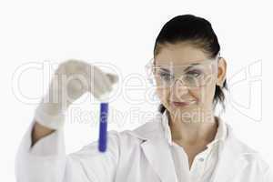 Isolated dark-haired scientist carrying out an experiment