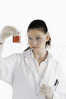 Dark-haired scientist conducting an experiment looking at a red