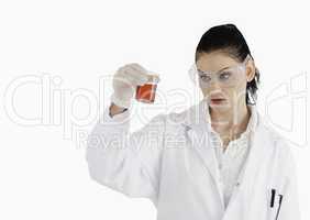 Dark-haired scientist with safety glasses looking at a red beake