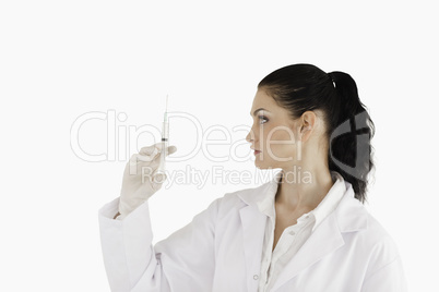 Doctor looking at a syringe